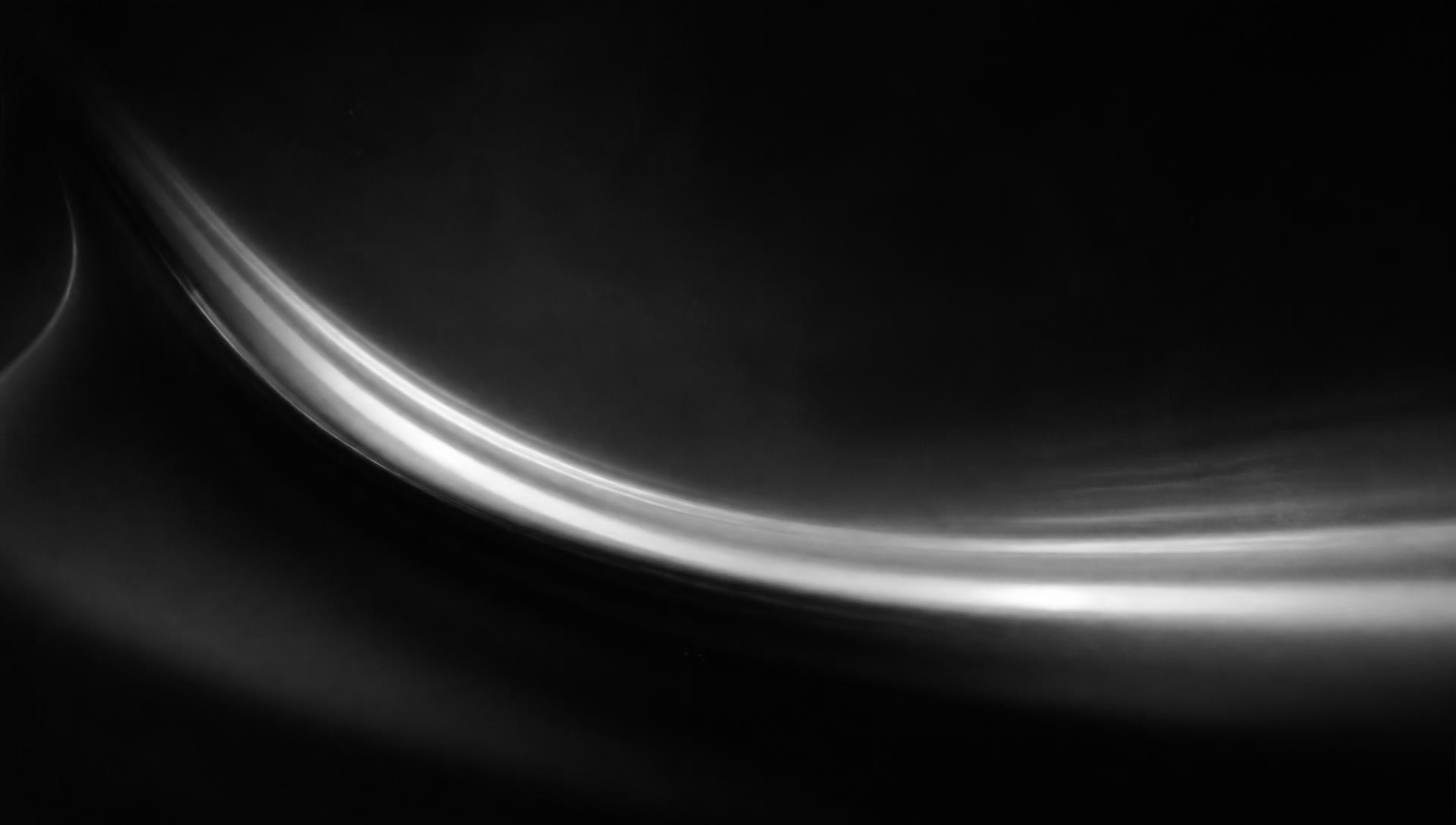 Abstract sweep of light bending through darkness
