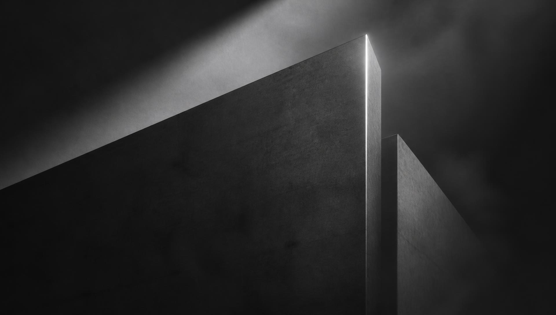 Monochrome architectural planes lit by a single edge of light